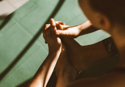 Close-up shot of feet on a yoga mat, indicating focus on movement.